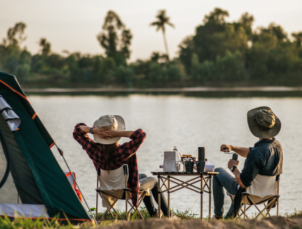 rear view young backpacker couple sitting relax front tent near lake with coffee set making fresh coffee grinder while camping trip summer vacation 1