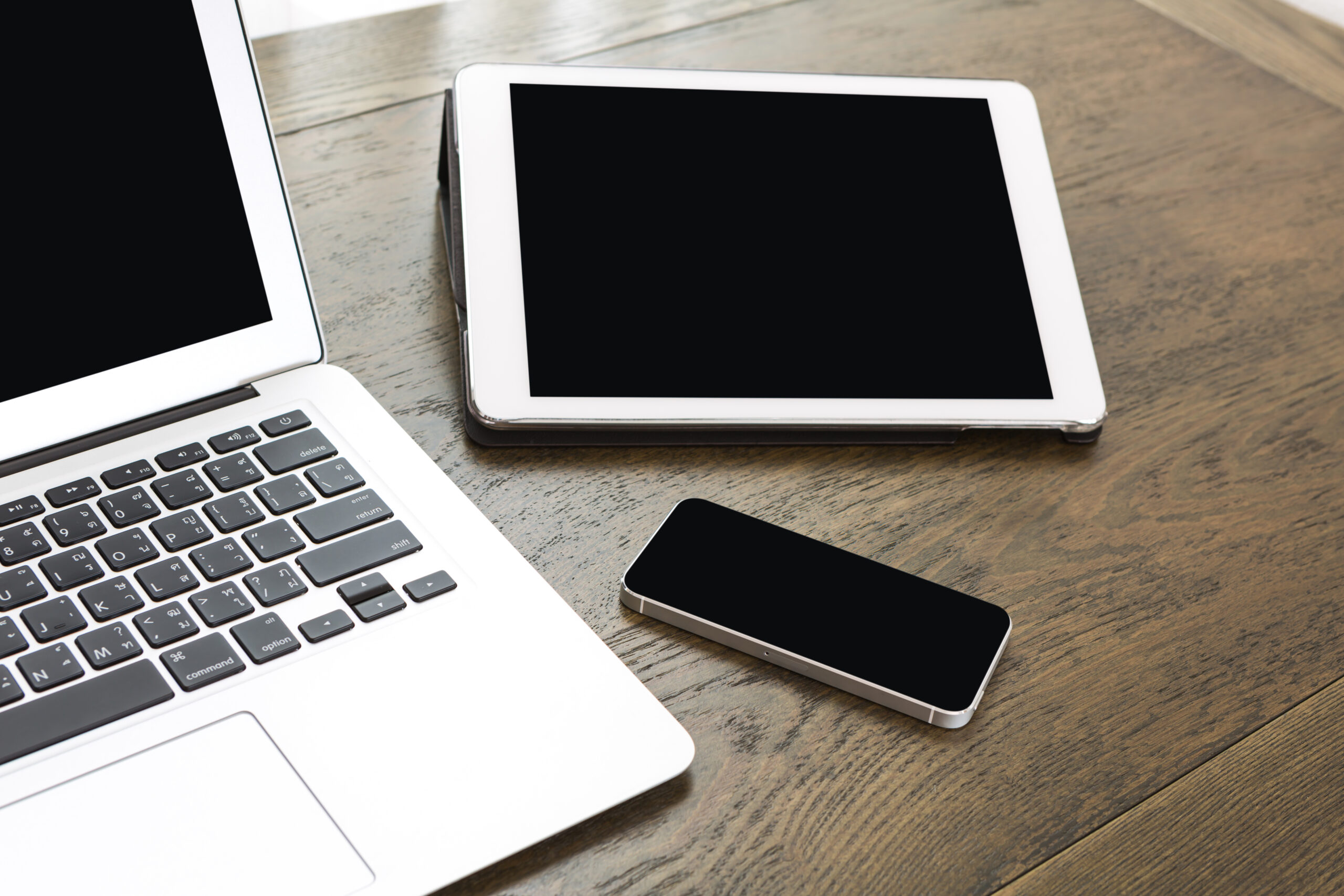 technological devices wooden table scaled